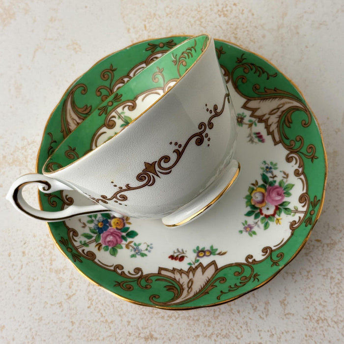 Back view of Tuscan Blenheim teacup laying on side on top of matching saucer