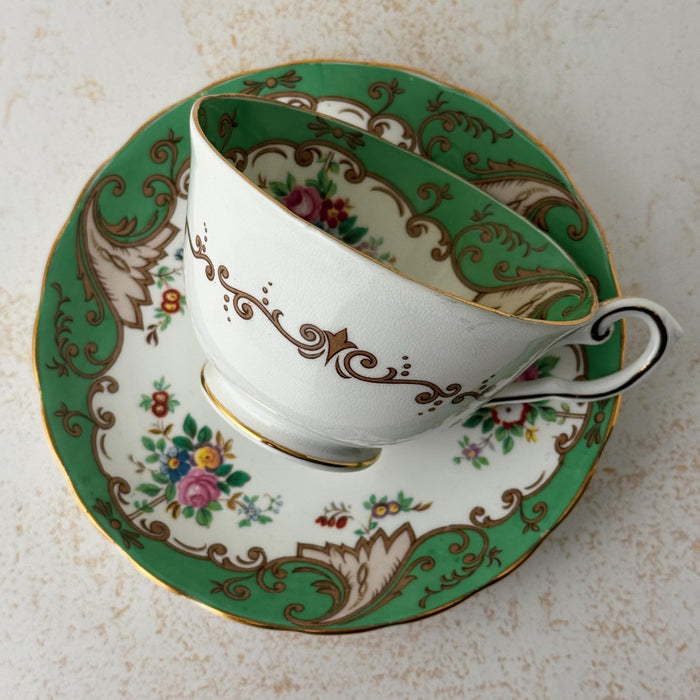 Front view of Tuscan Blenheim teacup laying on side on top of matching saucer
