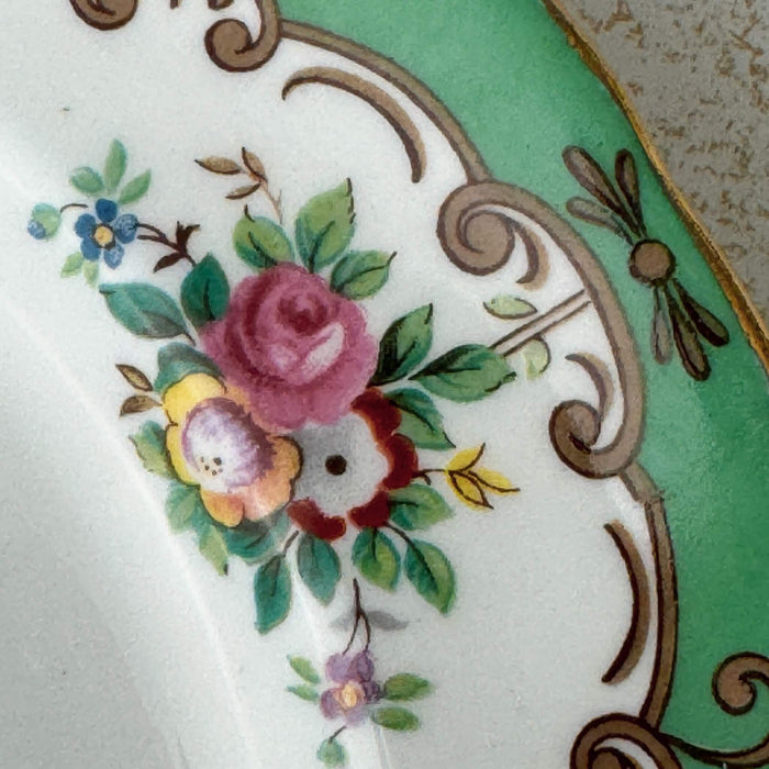 Close-up view of Tuscan Blenheim dessert plate floral decoration and green and gilt border