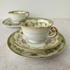 View of two Noritake Marlene Green tea trios with one trio in front of the other