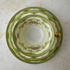 Top-down view of Noritake Marlene Green tea trio showing decorated teacup interior, layered porcelain pieces, green pattern, and gold edging