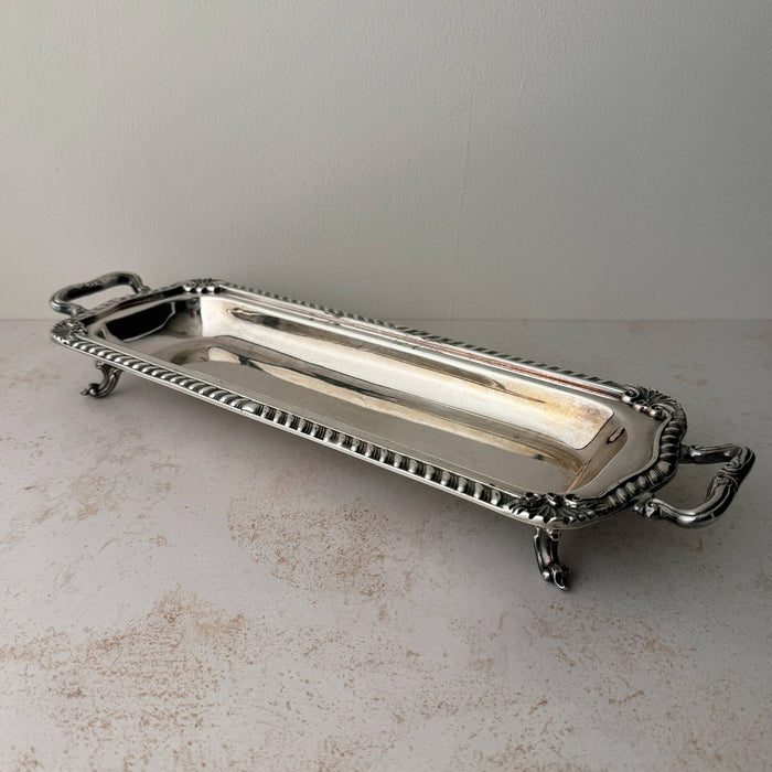 Angled three-quarter view of vintage silverplate rectangular serving tray