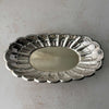 Top down view of vintage Towle silverplate oval bread tray with scalloped rim