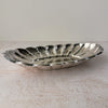 Angled side view of vintage Towle silverplate oval bread tray with scalloped rim