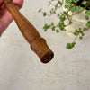 End view of brass candle snuffer's turned wood handle