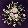 Close-up of center ribbon applique and embroidery on purple velvet floral ribbon accent pillow