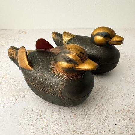 Facing right view of pair of vintage Japanese wooden mandarin duck incense boxes with dark matte finish and antique gold head, beak, and wing detailing