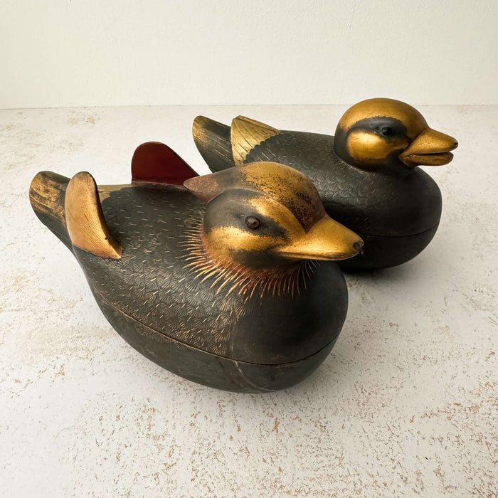 Facing right view of pair of vintage Japanese wooden mandarin duck incense boxes with dark matte finish and antique gold head, beak, and wing detailing