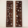 Front view of vintage hand-carved wooden panels with birds and flowers