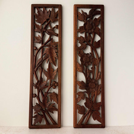 Front view of vintage hand-carved wooden panels with birds and flowers