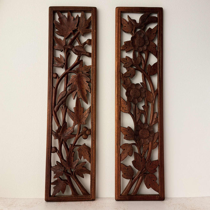Front view of vintage hand-carved wooden panels with birds and flowers