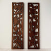 Back view of vintage hand-carved wooden panels with birds and flowers
