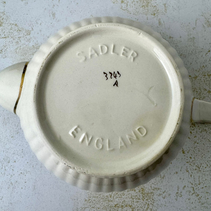 Underside of vintage Sadler teapot embossed SADLER ENGLAND with handwritten pattern number 3743 and letter A.