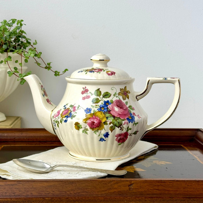 Vintage Sadler floral teapot styled on a wooden tray with a folded white linen and silver spoon.