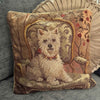 Vintage Westie needlepoint pillow styled on a chair with a round pleated cushion behind it.