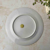 Reverse of vintage export porcelain plate showing plain white glaze and gold foil label