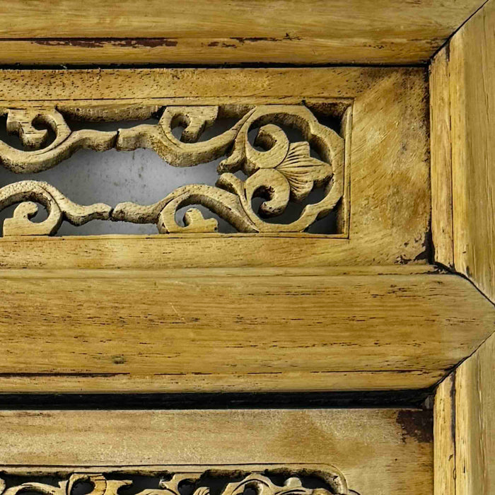 Close-up of vintage Chinese carved wood wall panel showing traces of original finish in corners and crevices