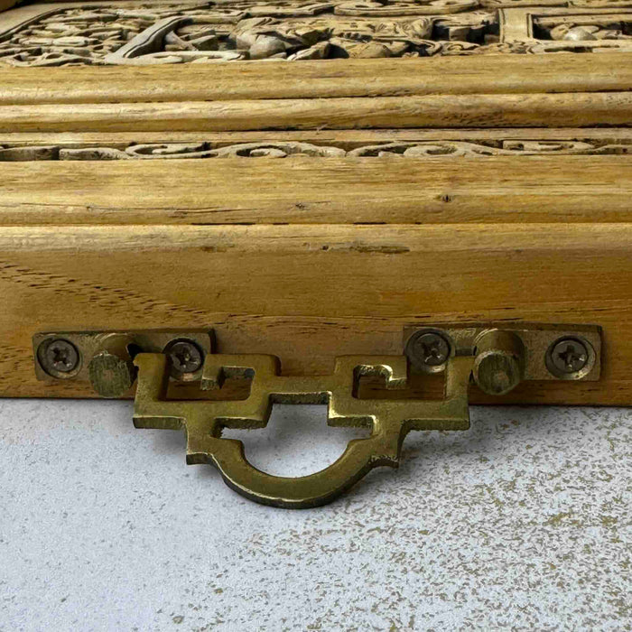 Close-up of brass hanging hardware on top edge of vintage Chinese carved wood wall panel