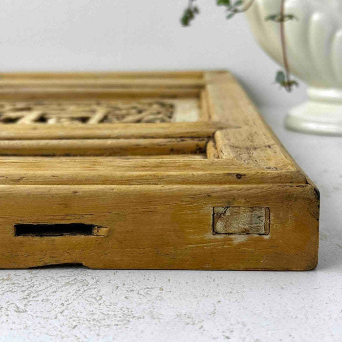 View of left top edge of vintage Chinese carved wood wall panel showing mortise joinery along the edge