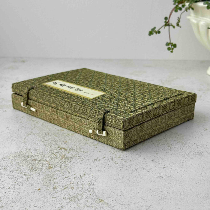 Vintage Chinese calligraphy set in textile-covered presentation box with geometric woven pattern, calligraphic label on lid and toggle closures