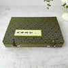 Top down view of closure side of vintage Chinese calligraphy presentation box on a light surface