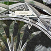 Extreme close-up of the glass dish showing fine surface scratches among the floral and geometric decoration.