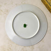 Overhead view of the undecorated white reverse and raised foot rim of the porcelain plate.
