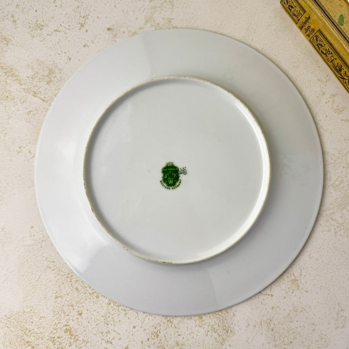 Overhead view of the undecorated white reverse and raised foot rim of the porcelain plate.