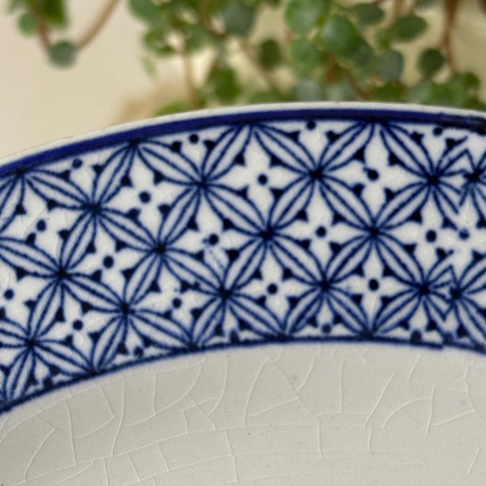 Close-up of blue geometric border pattern and visible crazing on a Wood & Sons Yuan plate.