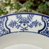 Close-up of blue floral border panel and surrounding geometric transfer pattern.