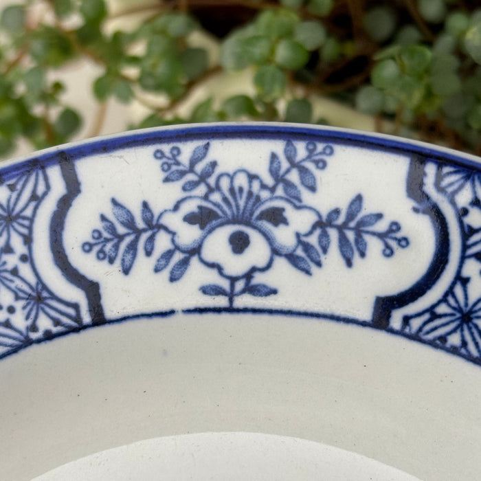 Close-up of blue floral border panel and surrounding geometric transfer pattern.