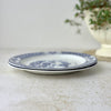 Side view of two stacked Wood & Sons Yuan plates showing their shallow profile and blue rims.
