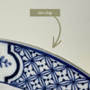 Close-up of shallow rim chip visible from the front of one Wood & Sons Yuan blue and white plate.