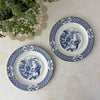 Pair of Wood & Sons Yuan blue and white plates displayed with a green plant and vintage crochet doily.