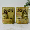 Front view of matching carved soapstone bookends featuring floral openwork and planter motifs