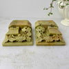 Top view of carved soapstone bookends highlighting pierced floral carving and dimensional openwork