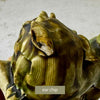 Close-up of one foo dog showing a chip to the ear with visible age-related wear and glaze variation