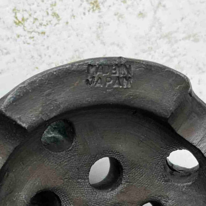 Close-up of the Made in Japan mark on the underside of the vintage ceramic flower frog.