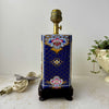 Alternate side view of the vintage peacock lamp showing floral side motifs and ceramic panel detailing