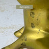 Close-up showing several dark spots on the leg and lower body of one brass pig bookend.