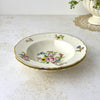 Angled view of two stacked vintage Syracuse China Portland bowls with colorful floral decoration and gold-trimmed scalloped rims.