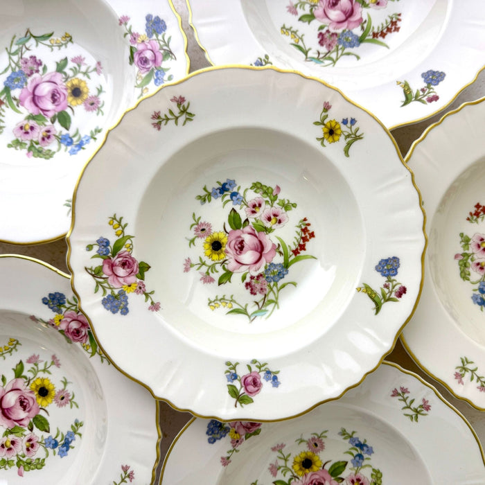 Group of vintage Syracuse China Portland soup bowls showing the repeating mixed floral bouquets and scalloped gold rims.