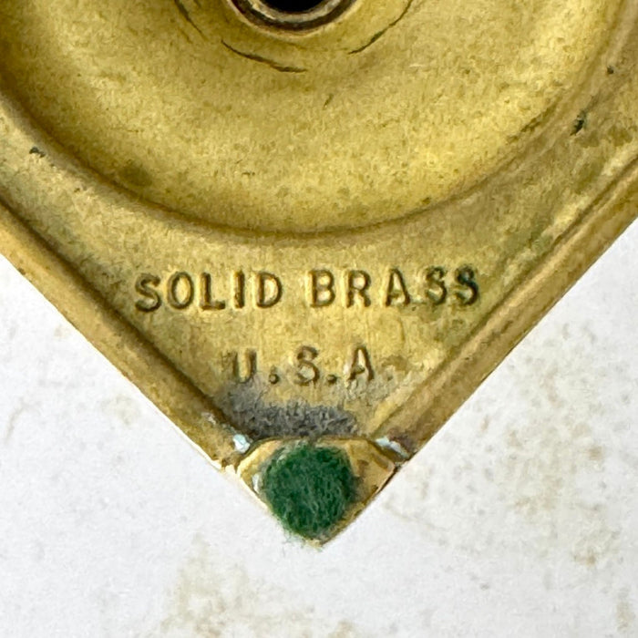 Close-up of Solid Brass U.S.A. mark on the underside of the shorter Ethan Allen candlestick.