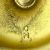 Close-up of CM mark on the underside of the taller vintage brass candlestick.