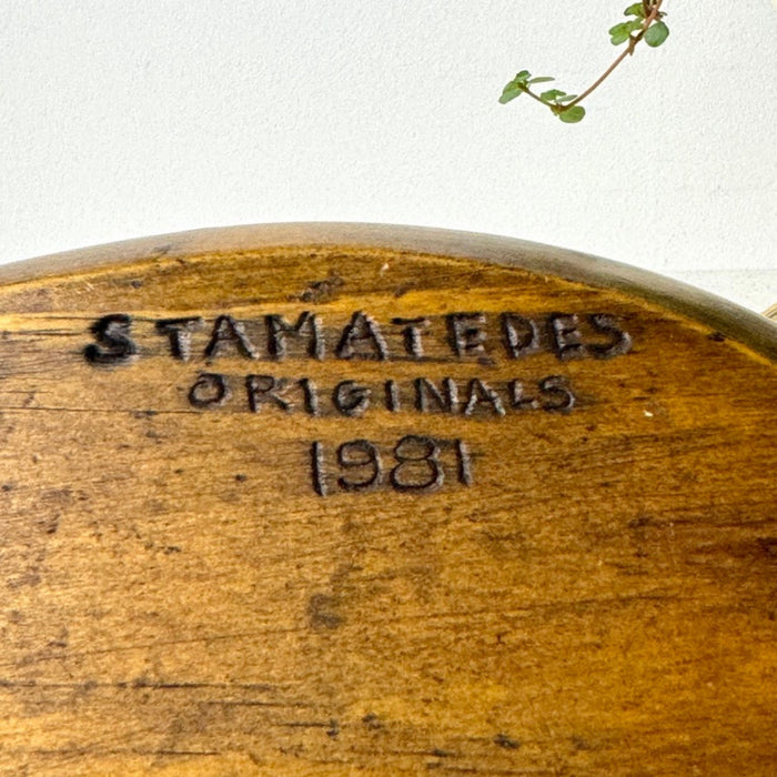 Close-up of wood-burned underside mark reading “Stamatedes Originals 1981.”