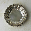 Overhead view of vintage International Silverplate bowl showing the fluted interior and ornate floral and scroll border.