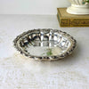 Vintage International Silverplate bowl with a fluted body and ornate raised floral and scroll border.