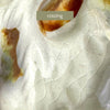 Close-up of ceramic dog figurine showing fine crazing across the white glazed surface.
