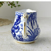 Handle-side view of Blue Mikado creamer showing cobalt blue landscape decoration and gold detailing on the handle and rim.