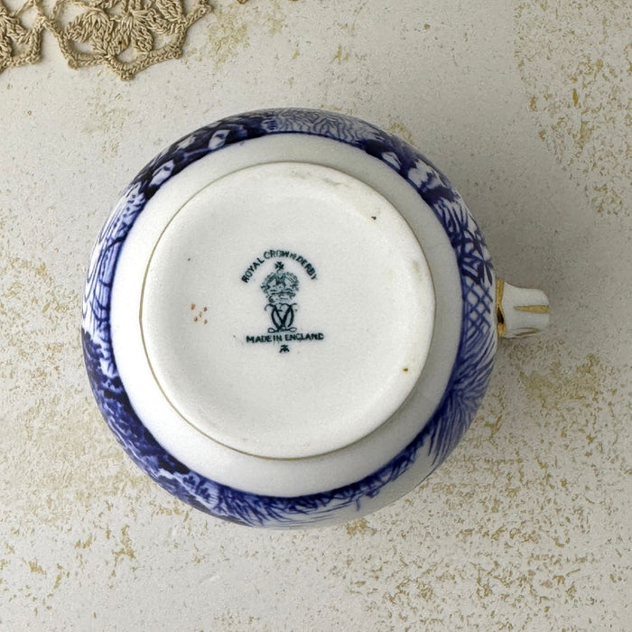 Underside of Royal Crown Derby Blue Mikado creamer showing the foot and blue-green factory backstamp.